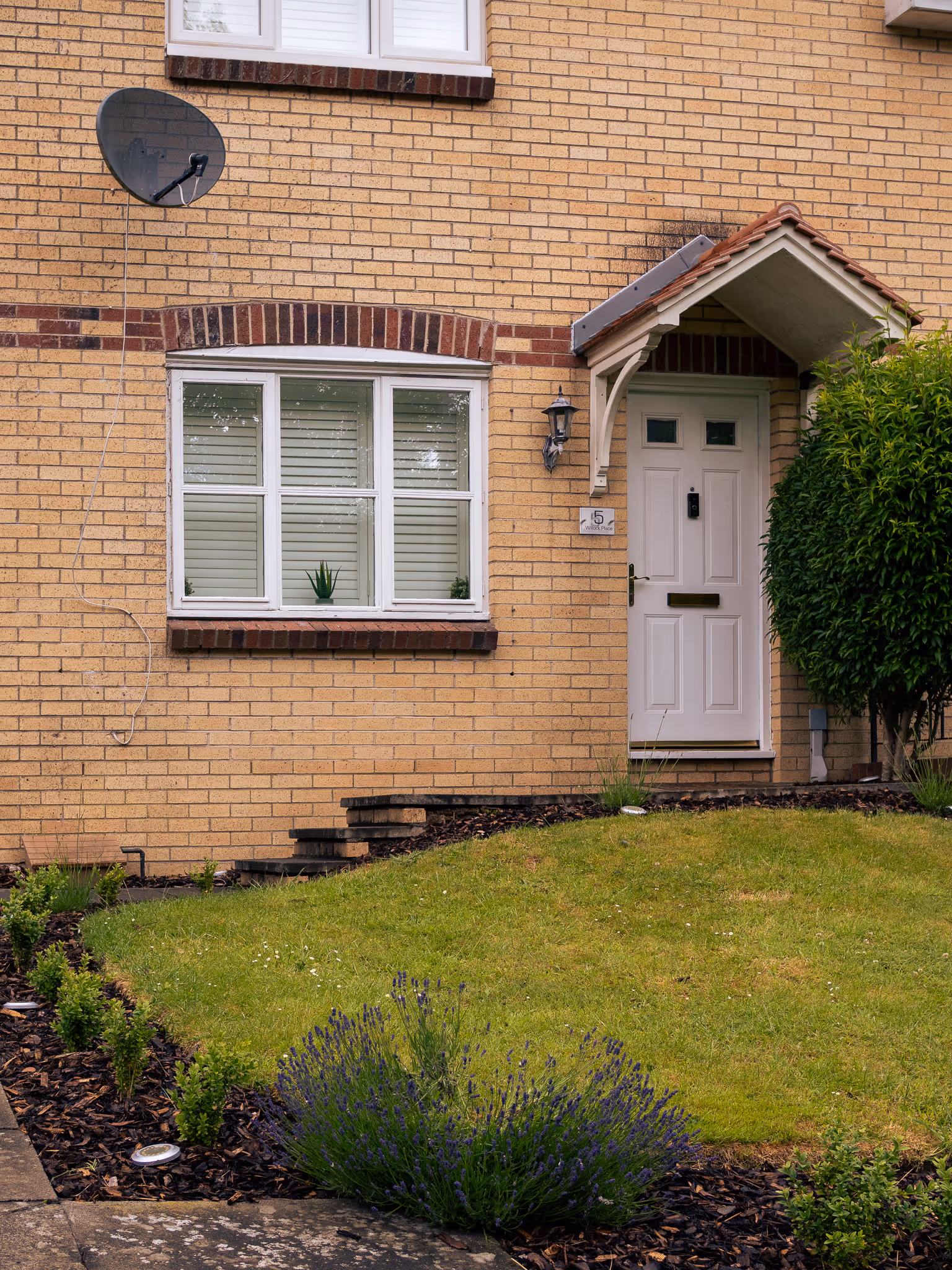 Traditional stone-front house with front garden